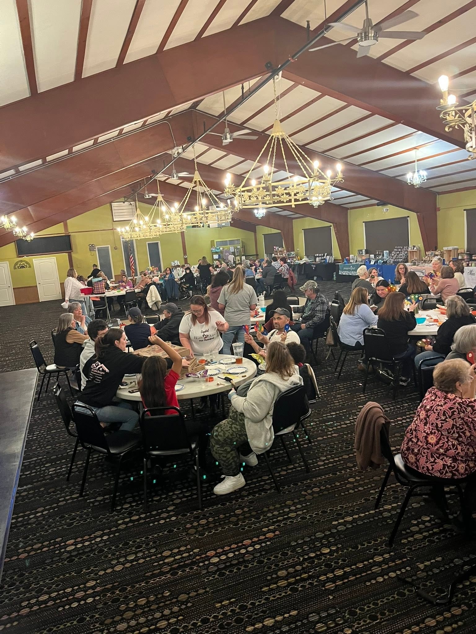Attendees seated at round tables during a Hearts with Hope Quarter Auction fundraiser